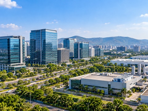 Glass office towers and industrial units on a Pune business park road, hills behind